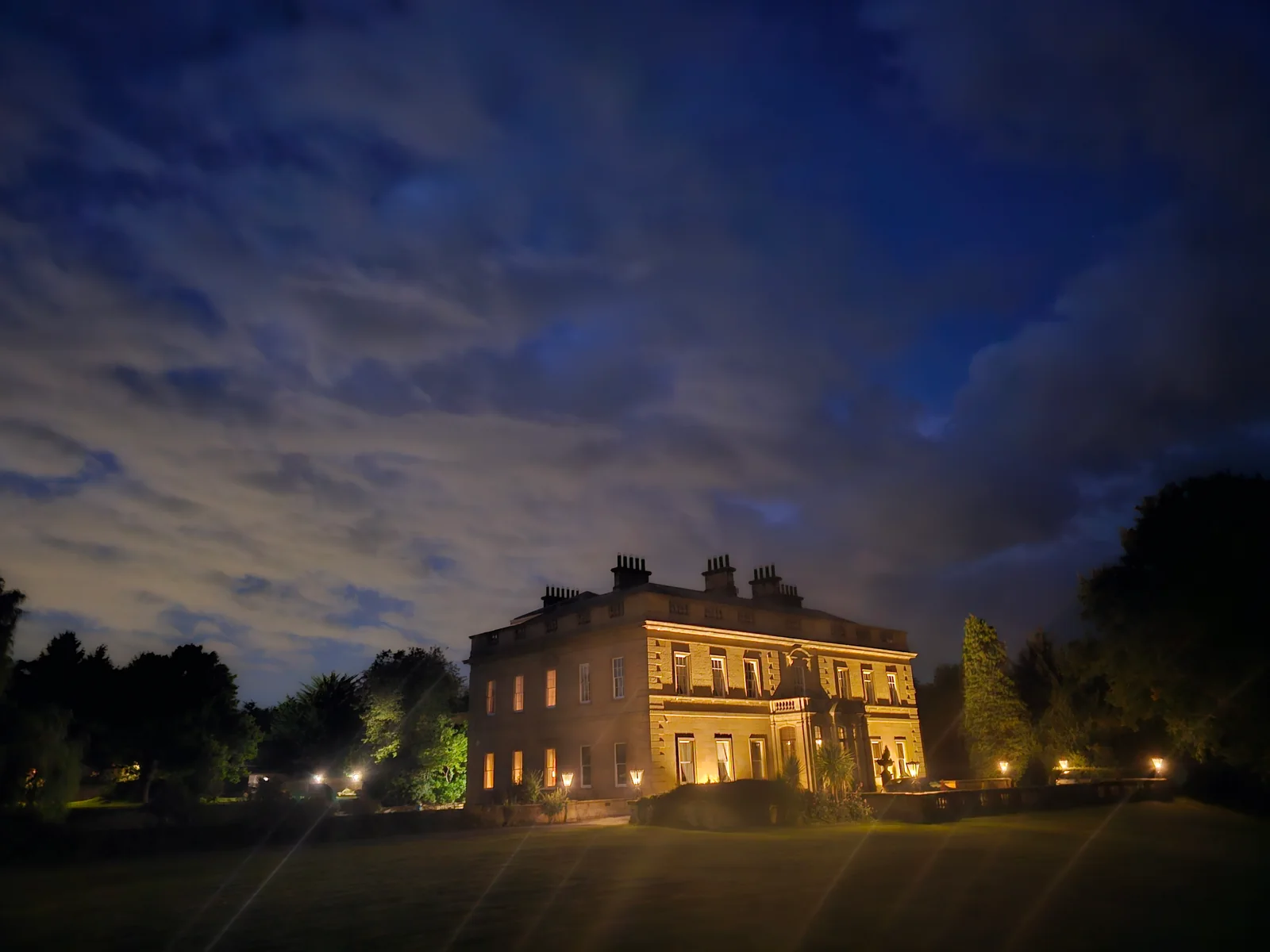 Rudby Hall illuminated beneath a darkening evening sky.