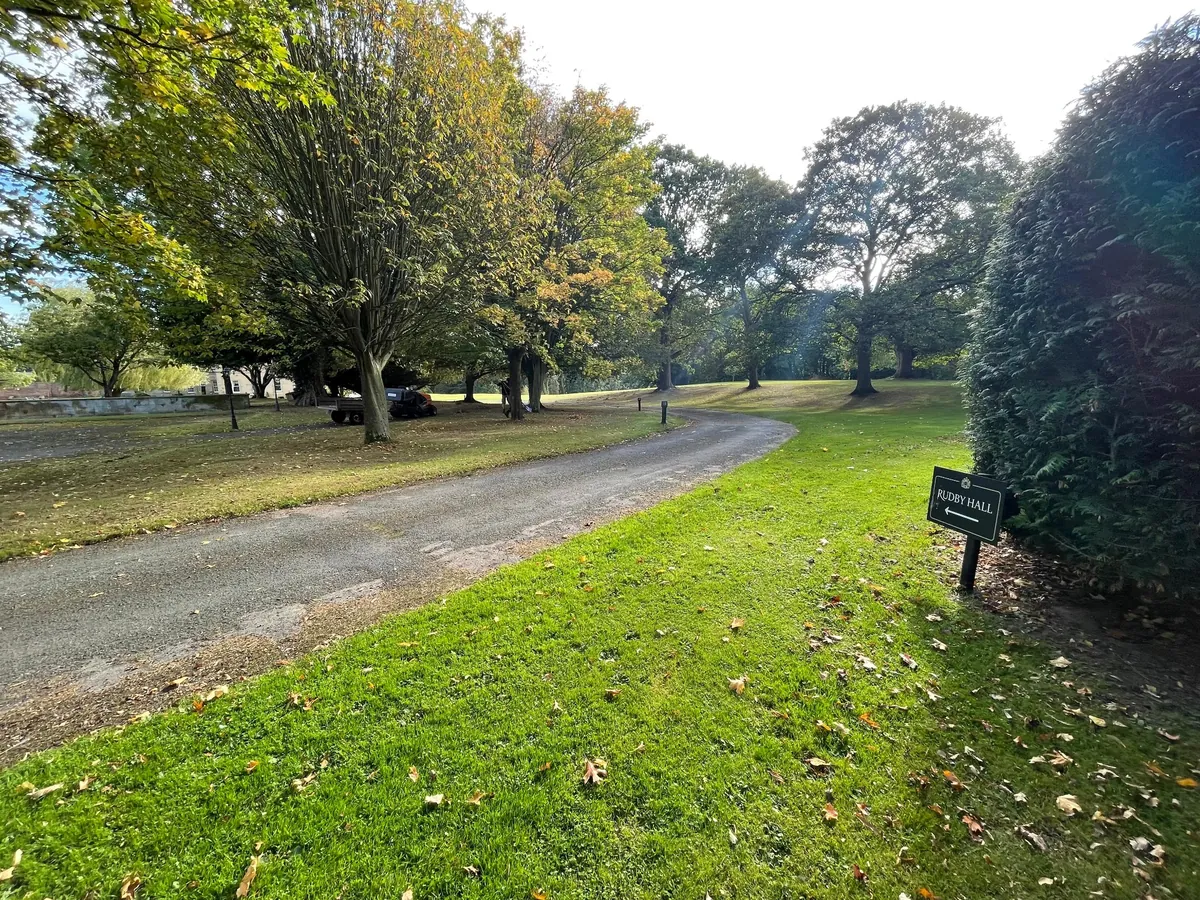 Autumn trees and the curving drive at the Rudby Hall Estate approach